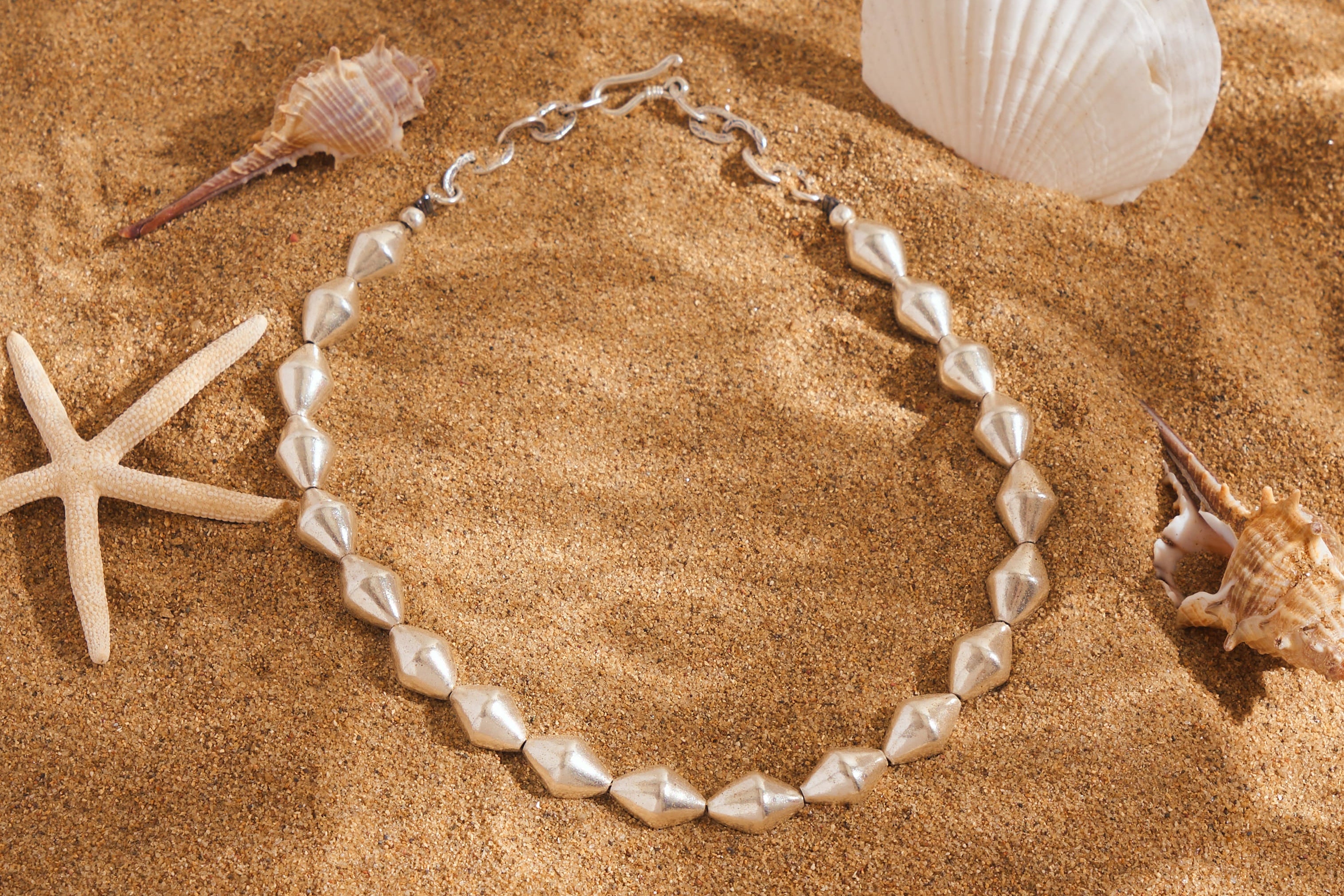 Handcrafted pure silver marquise bead necklace by Hill To Street, photographed from above