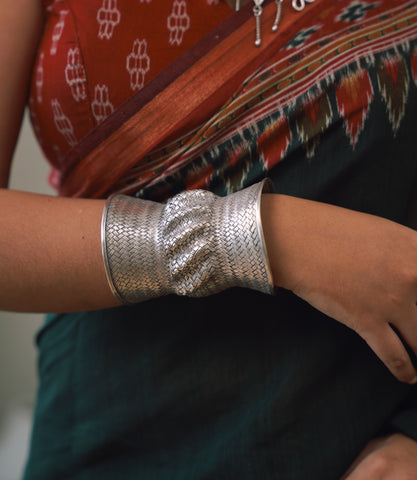 Solenne Pure Silver Woven Cuff worn on wrist, styled as a bold artisan statement piece with casual everyday outfit