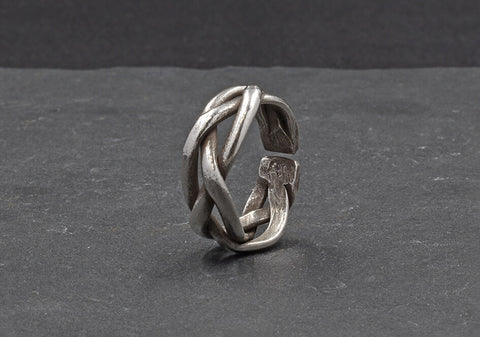 Close-up of Taylor Ring showing intricate twisted line detail and brushed pure silver finish.