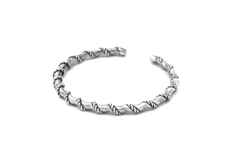 Close-up of intricately twisted pure silver wire texture on the Vienna Twisted Bangle cuff.