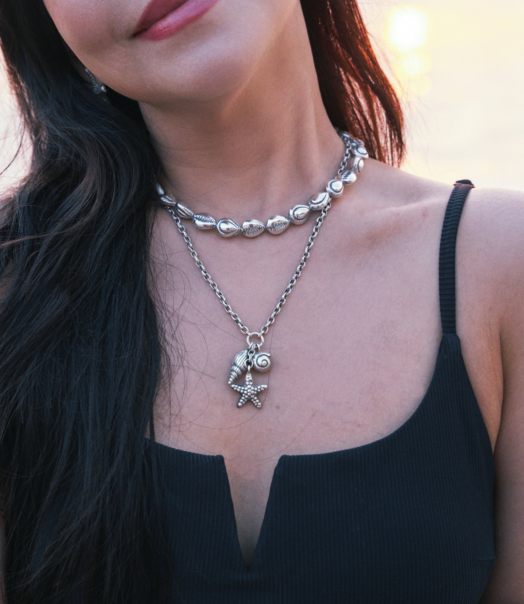 Model wearing The Cordelia Charm Necklace, a pure silver sea charm necklace for everyday styling.