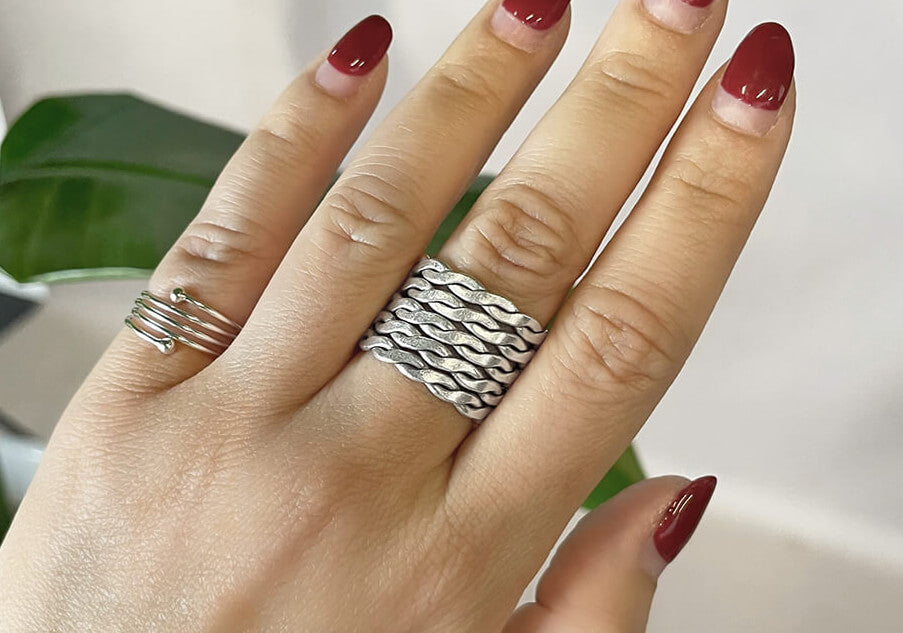 Remy Twisted Weave Silver Ring worn on finger, styled as a unisex statement band for everyday or occasion wear