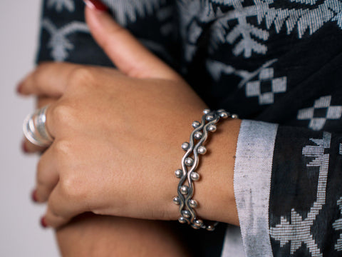 Model wearing Mariela Bangle, a sculptural pure silver bracelet for everyday styling.