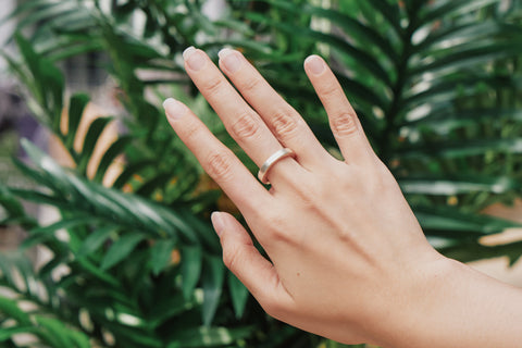 Aiden Band Ring worn on hand, stacked with other silver rings for a modern layered look