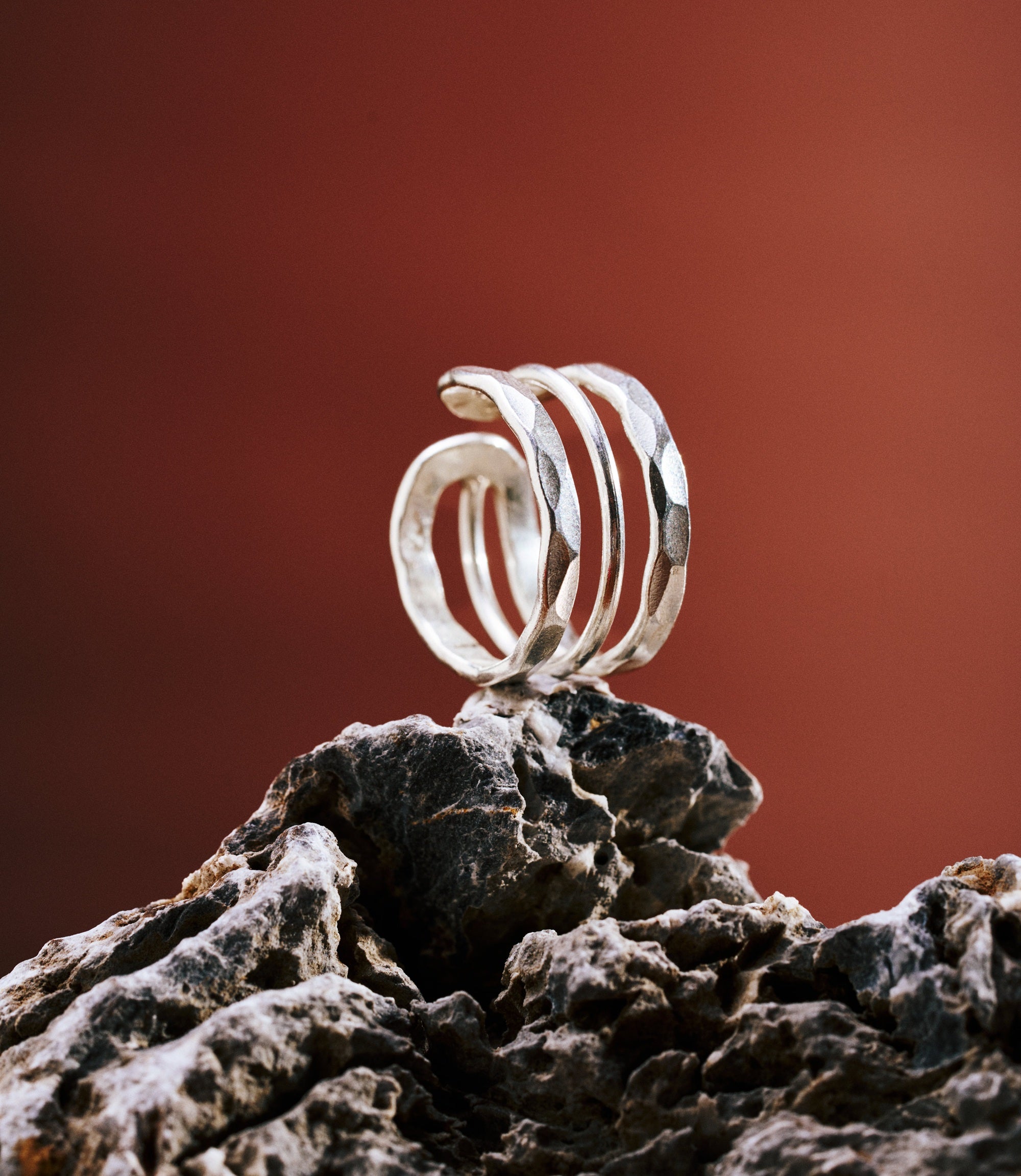 Close-up of the Ashley ring featuring a wide hammered band with fine linear detailing.