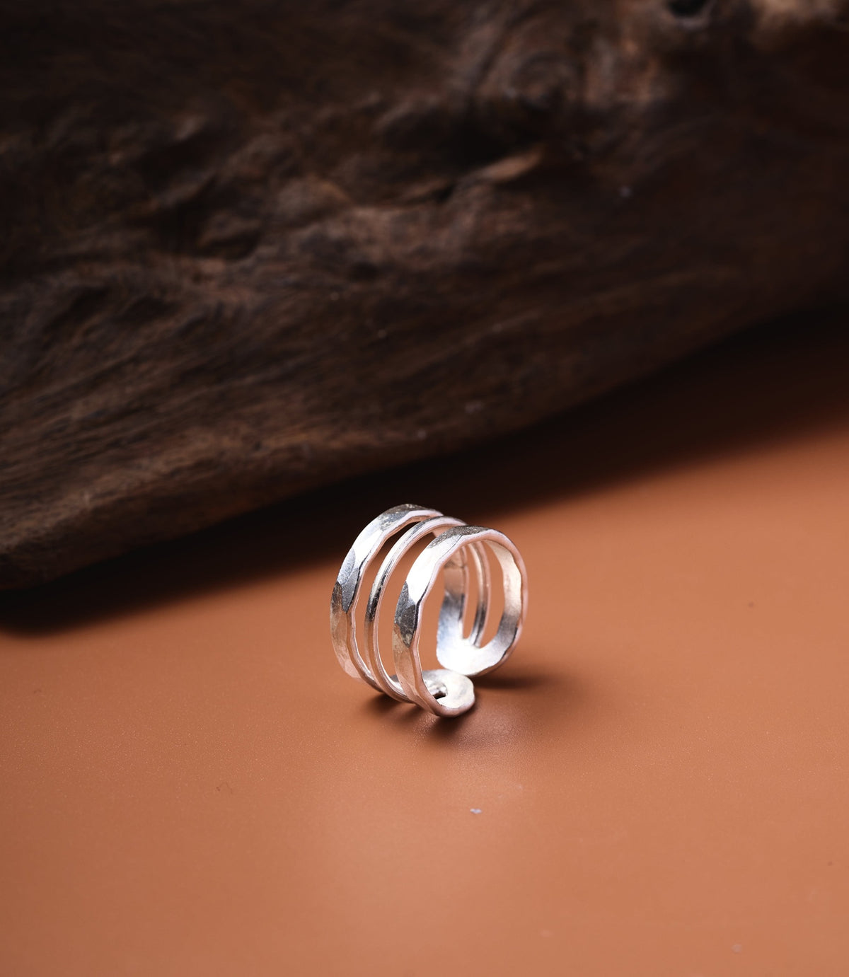 The Ashley Ring in pure silver featuring a wide hammered band with fine linear detailing.