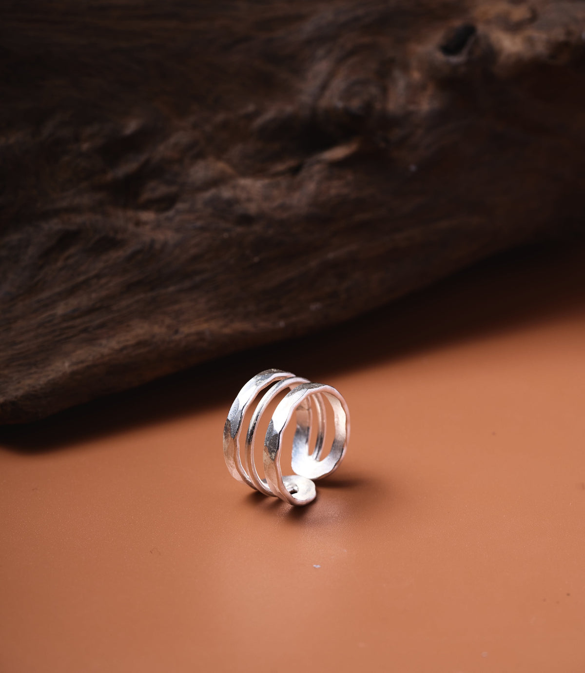 The Ashley Ring in pure silver featuring a wide hammered band with fine linear detailing.