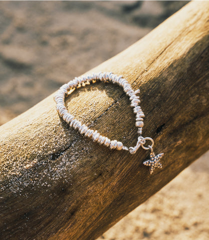 The Cora Bracelet in pure silver featuring handcrafted irregular silver beads with a starfish charm.
