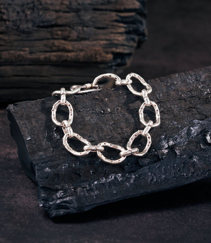 Delilah Chain Bracelet in pure silver with sleek interlocking chain links, laid flat on a clean surface