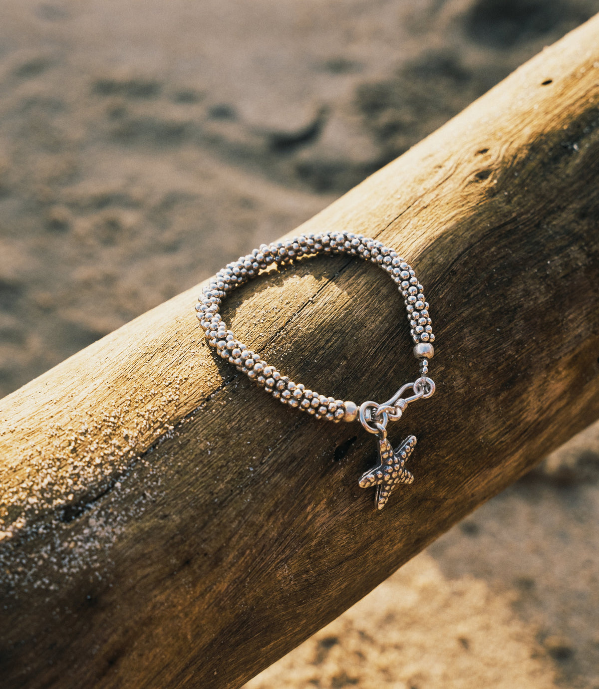 The Elizabeth Bracelet in pure silver featuring polished silver ball beads and a handcrafted starfish charm.