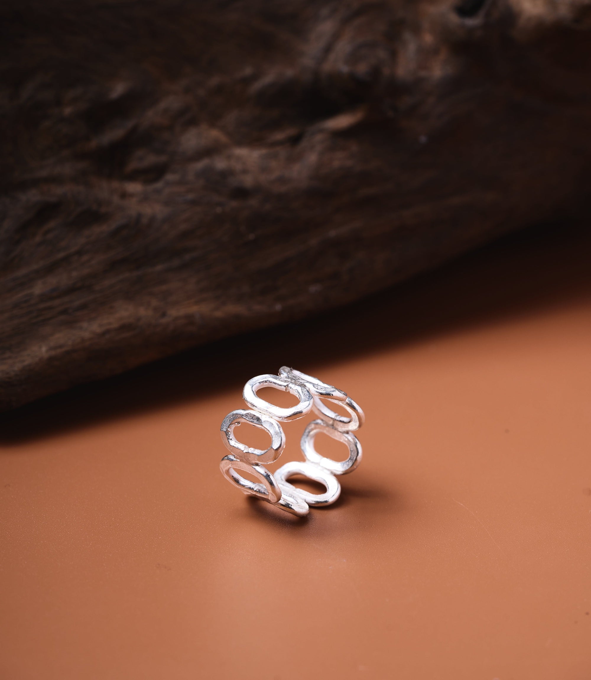The Ember Ring in pure silver featuring an adjustable multi-circle design with a sculptural open band.