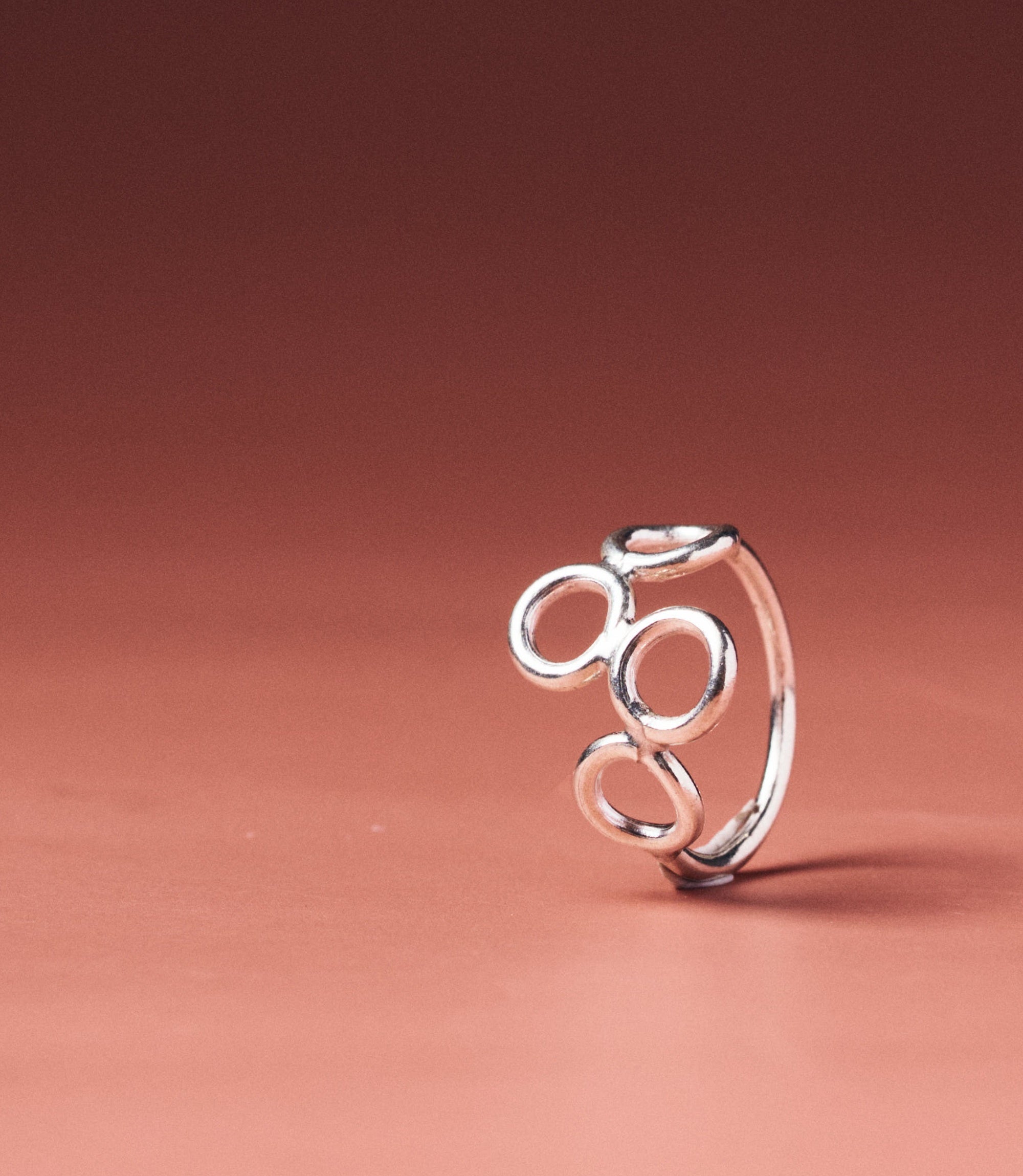 Lena Multi-Circle Pure Silver Ring with three open linked circles on a thin wire band