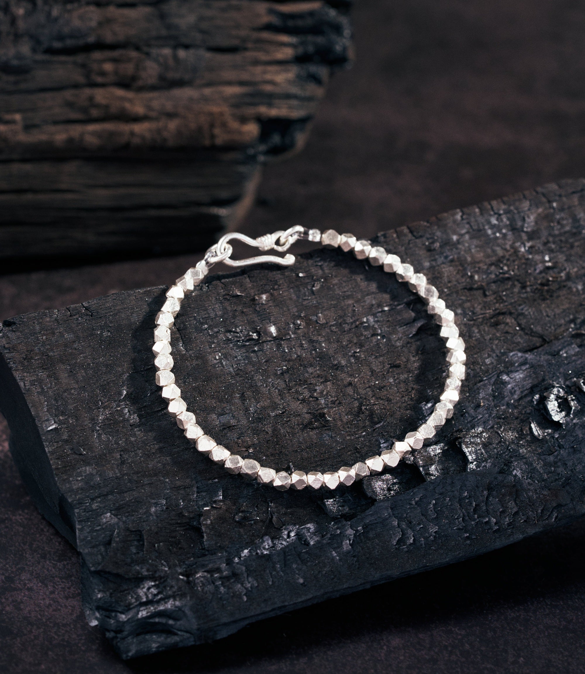 Lumin Bracelet in pure silver featuring multi-faceted beads with a high-shine reflective finish