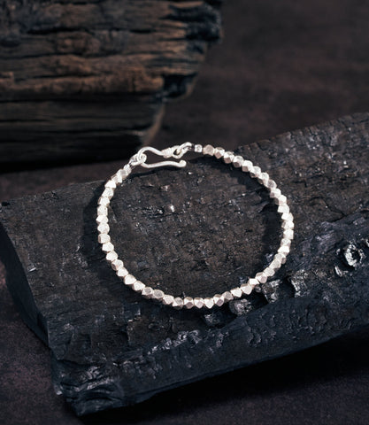 Lumin Bracelet in pure silver featuring multi-faceted beads with a high-shine reflective finish