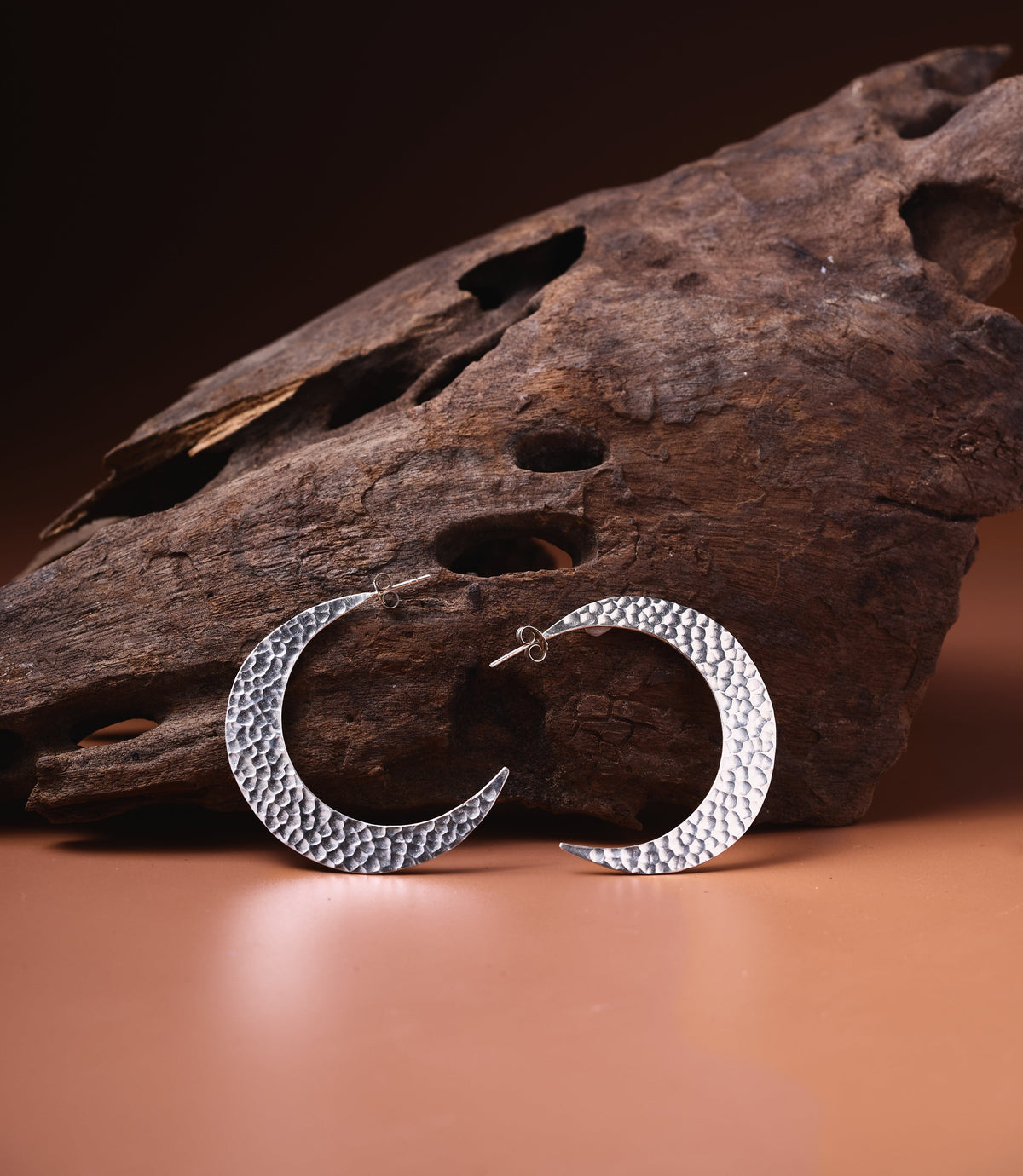 Luna Hoop earrings in pure silver showing a delicate crescent shape and hammered finish.