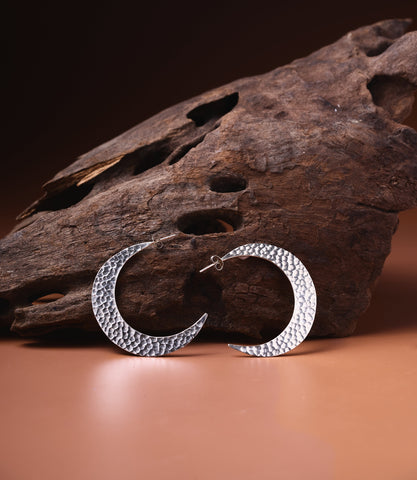 Luna Hoop earrings in pure silver showing a delicate crescent shape and hammered finish.