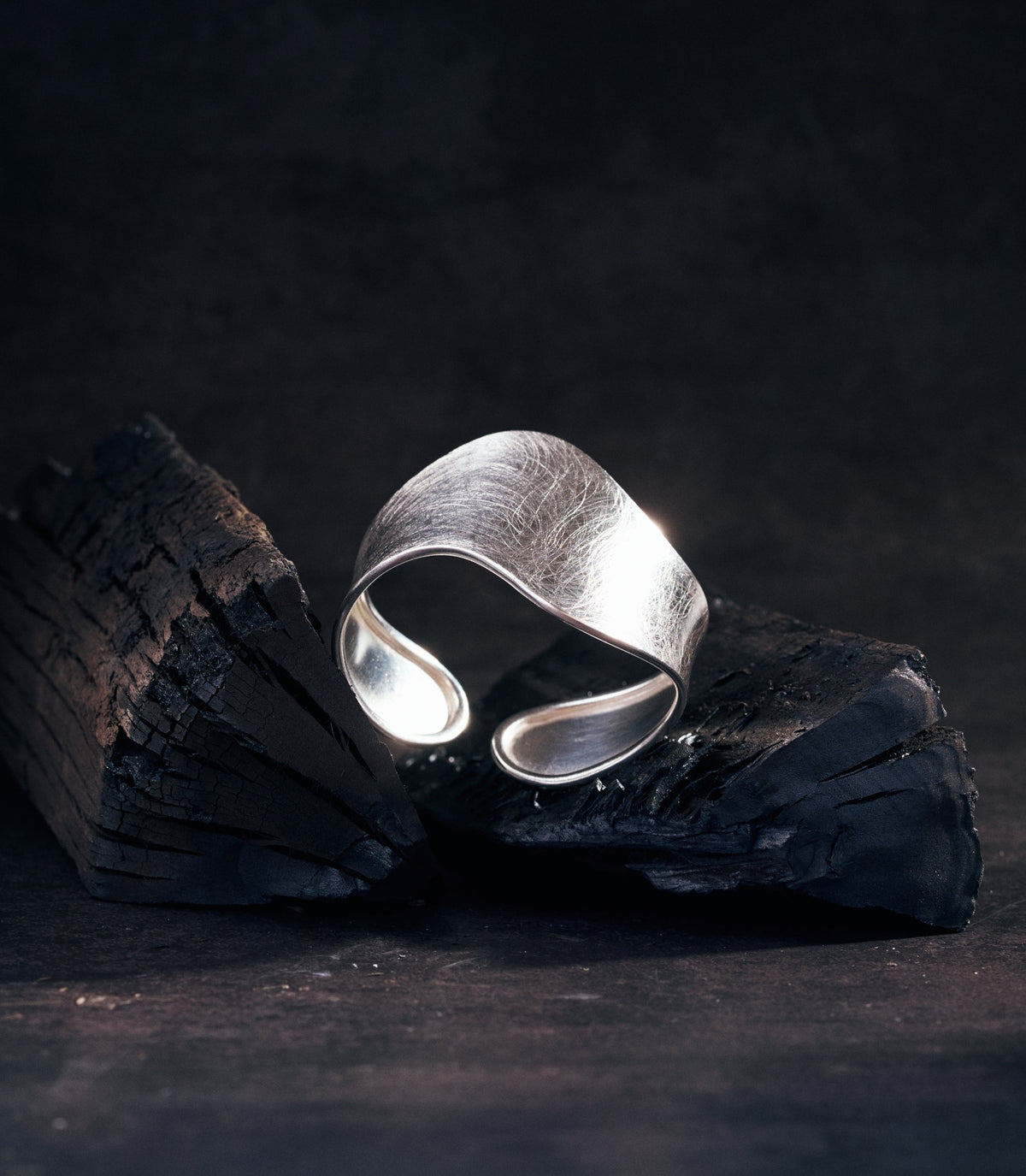 Lydia Bangle in pure silver showing a flowing wave silhouette with a soft matte finish.