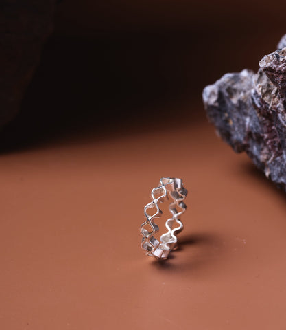 Lyra Pure Silver Wave Ring styled on a neutral stone surface highlighting artisan craftsmanship