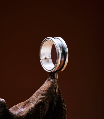 Morgan Band Ring in pure silver worn on hand, styled as a couple ring set