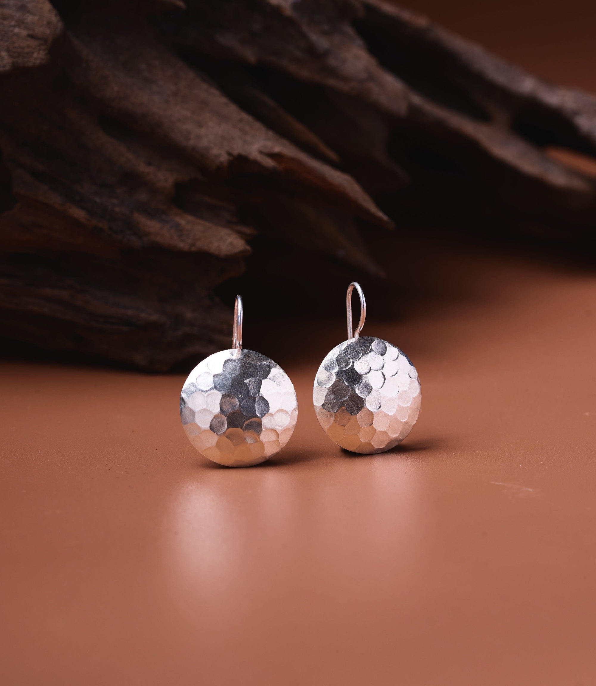 Naia pure silver hammered disc drop earrings with textured surface and shepherd hook wires