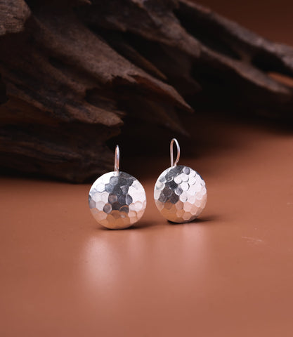 Naia pure silver hammered disc drop earrings with textured surface and shepherd hook wires