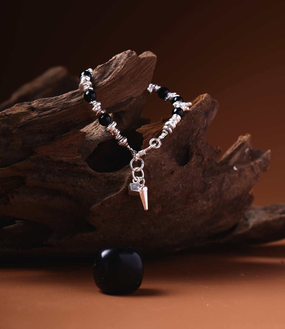 Raven Onyx Charm Bracelet handcrafted with black Onyx beads, pure silver beads, and a silver spike charm