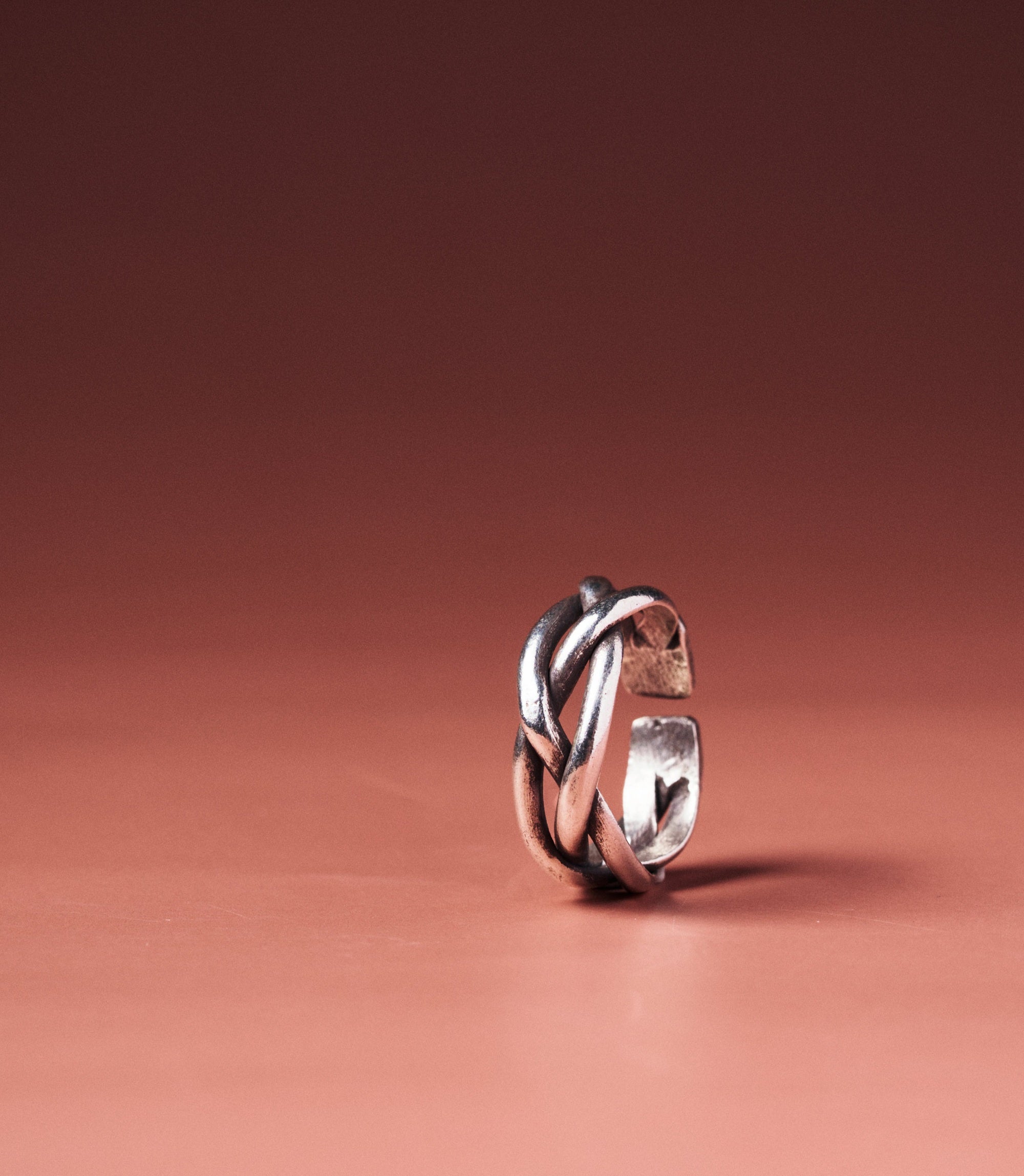 Taylor Ring in pure silver showing twisted intersecting lines in textured form.