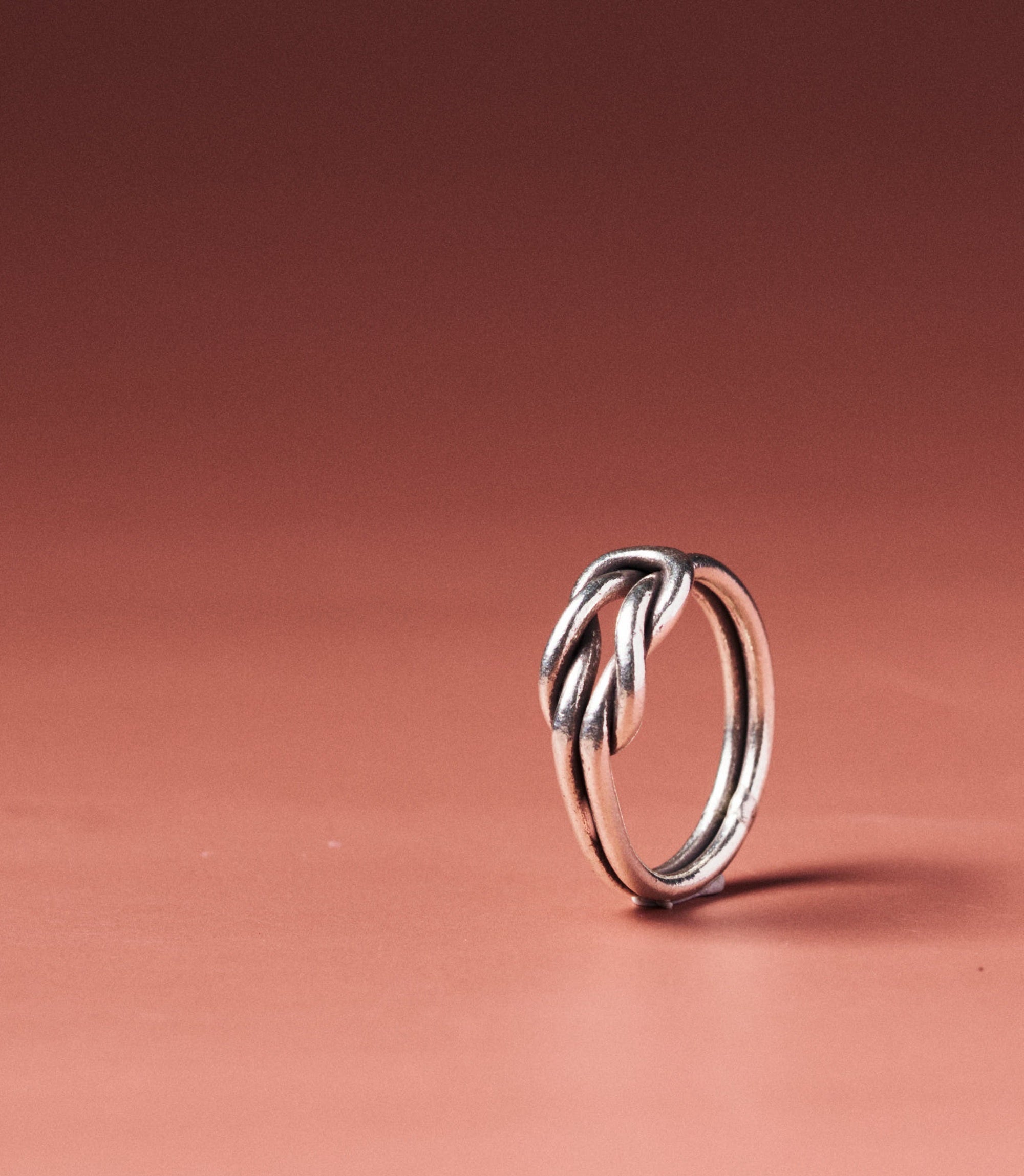 Lyra Square Knot Ring in pure silver with sculptural square knot detail, front view