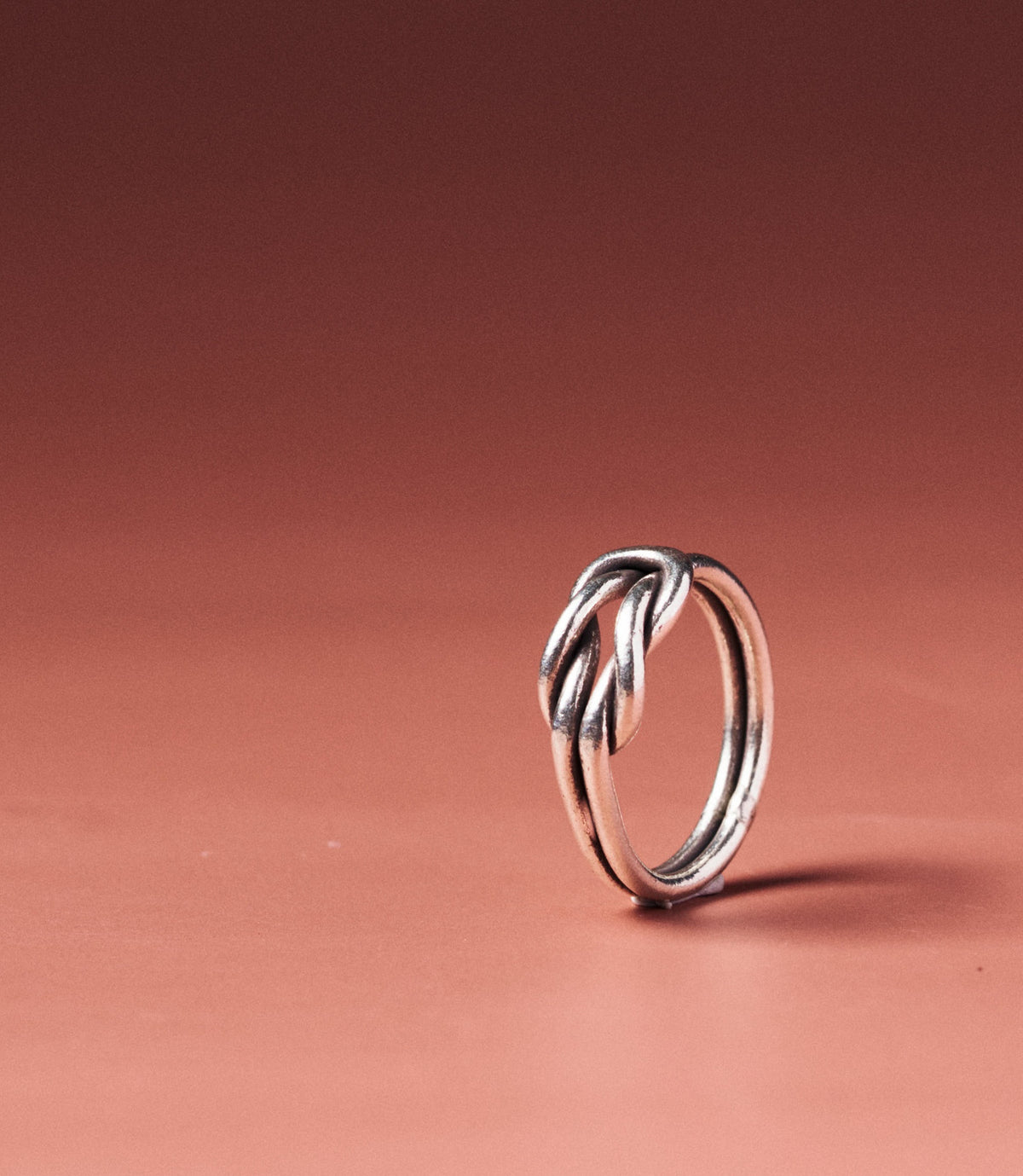 Lyra Square Knot Ring in pure silver with sculptural square knot detail, front view