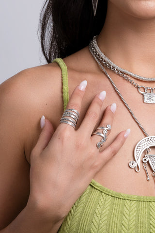 Model wearing multi-strand silver ring from Hill to Street with a green top