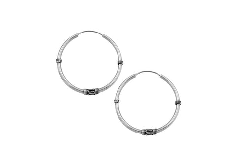 Close-up of Nina Earrings showing thick hoop construction and polished 925 sterling silver finish.