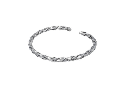 Twisted bangle with fine stamped details from Hill to Street over a white background