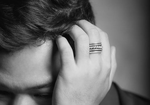 Black and white photo of a model wearing a twisted silver band ring from Hill to Street