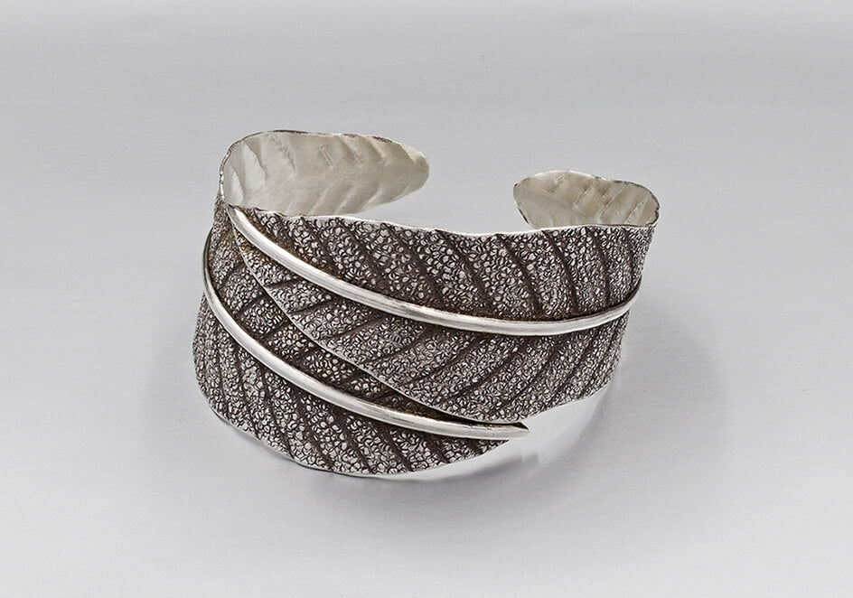 Wrap-around leaf statement cuff from Hill to Street over a plain grey background