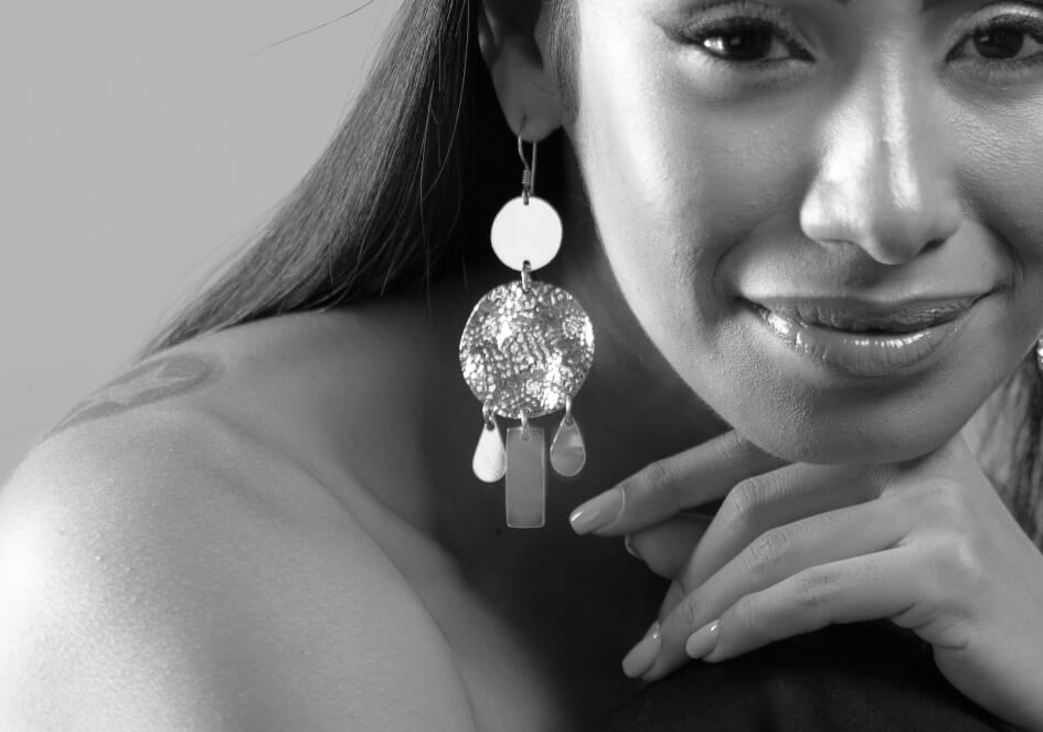 Zoom-in photo of model wearing Athena silver drop earrings from Hill to Street