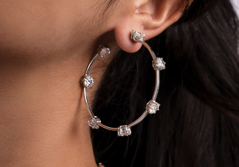 Zoomed-in photo of model wearing a pair of Cubic Zirconia hoop earrings from Hill to Street