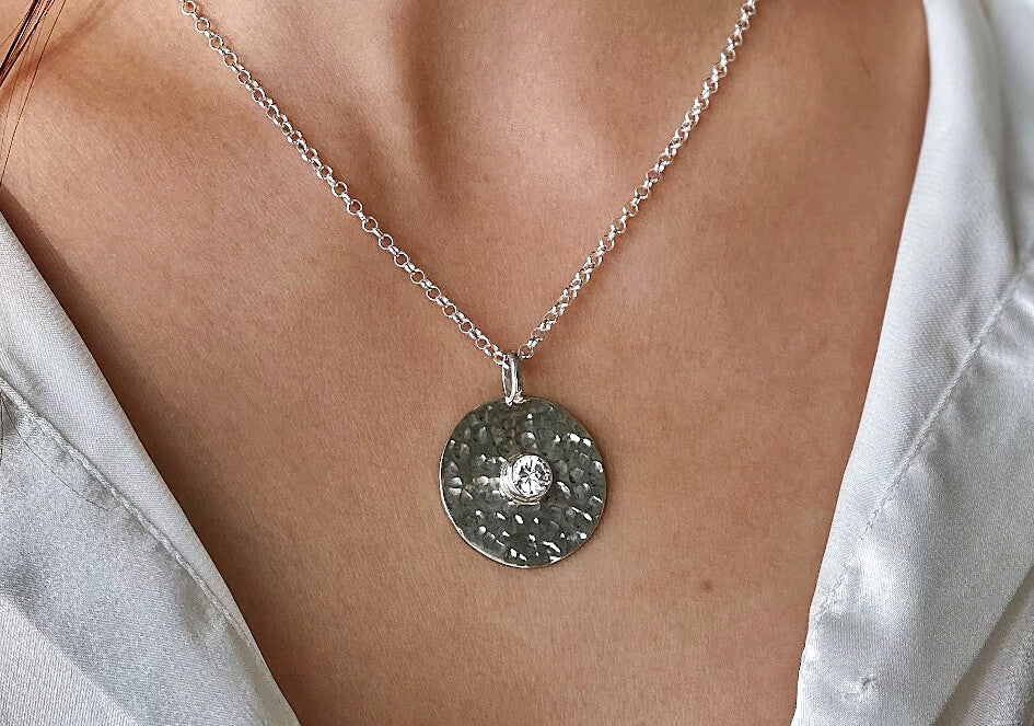 Zoomed-in photo of model wearing a Cubic Zirconia round pendant necklace set from Hill to Street