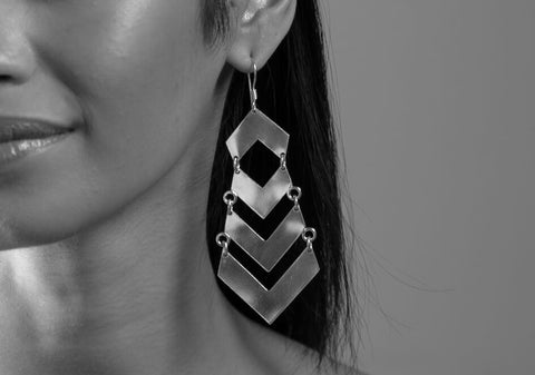 Black and white photo of model wearing dramatic arrows silver drop earrings from Hill to Street
