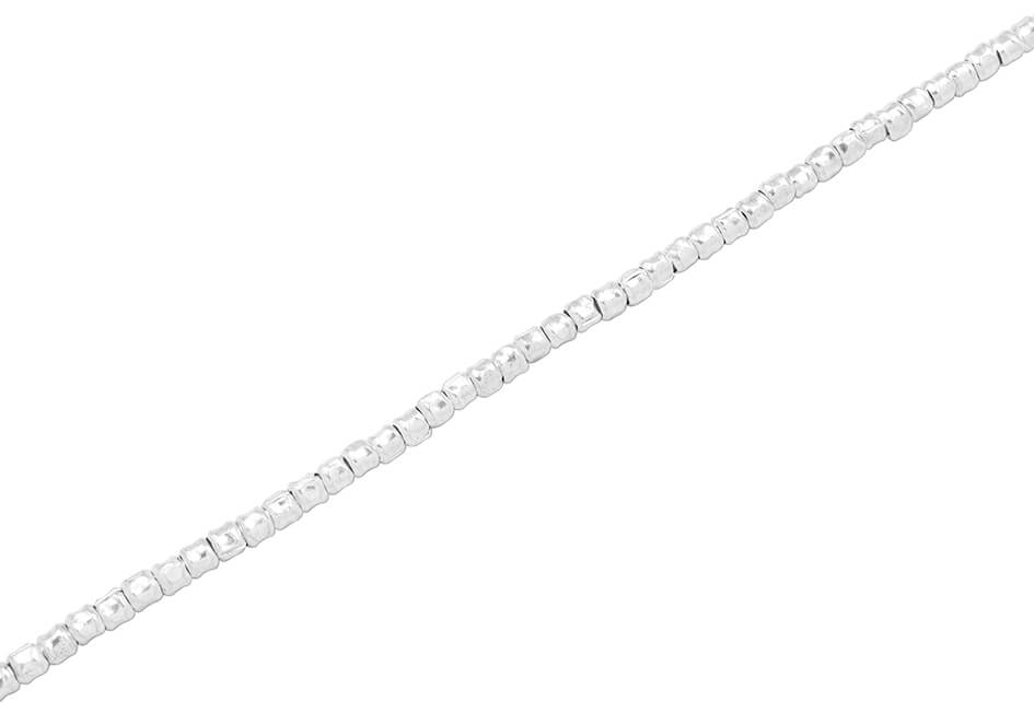 Irregular round silver beads anklet from Hill to Street over a white background
