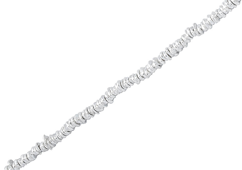 Irregular silver beads anklet from Hill to Street over a white background