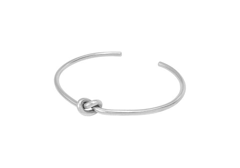 Minimalist knotted silver bracelet from Hill to Street over a white background