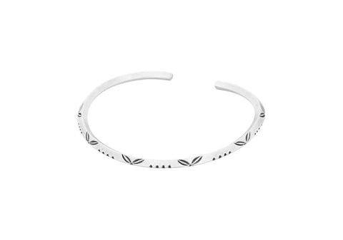 Minimalist stamped leaf triangle silver bangle from Hill to Street over a white background