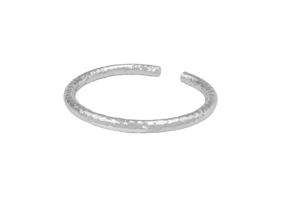 Round hammered open-cuff silver bracelet from Hill to Street over a white background