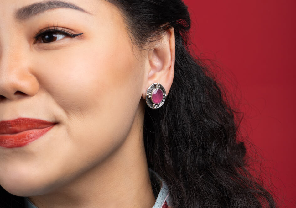 Model wearing a pair of ruby silver clip-on earrings from Hill to Street