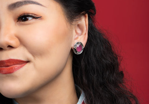 Model wearing a pair of ruby silver clip-on earrings from Hill to Street