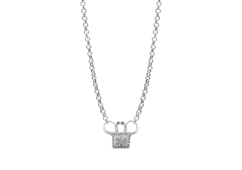 Small spirit lock of the Hmong necklace from Hill to Street over a white background