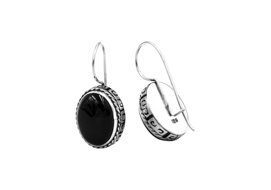 Pair of sterling silver drop earrings with black onyx from Hill to Street over a white background