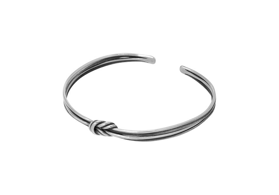 Thin knotted wire silver bracelet from Hill to Street over a white background