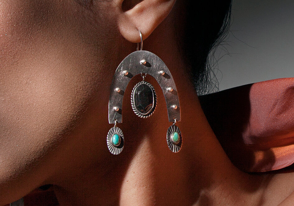 Zoomed-in photo of model wearing a pair of Virya drop earrings from Hill to Street